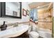 Well-lit bathroom featuring tile flooring, a modern vanity with a large mirror, and a combined tub and shower at 2215 Meade St, Denver, CO 80211