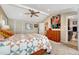 Comfortable bedroom with a ceiling fan, a bright window, a bed with patterned bedding, and ensuite bathroom access at 2215 Meade St, Denver, CO 80211