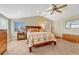 Bright bedroom features a decorative bedspread, vaulted ceiling with fan, and natural light from the window at 2215 Meade St, Denver, CO 80211