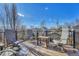 This outdoor deck features four chairs and a table overlooking the neighborhood on a sunny day at 2215 Meade St, Denver, CO 80211