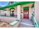 Charming front porch area with seating and red door with green trim at 2215 Meade St, Denver, CO 80211