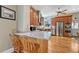 Open kitchen showcasing a large granite island with bar seating, stainless steel appliances, and hardwood floors at 2215 Meade St, Denver, CO 80211