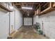 Unfinished garage with exposed ceiling and a white door at 3531 E 122Nd Ave, Thornton, CO 80241