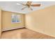 This bedroom features laminated wood floor, yellow walls, a ceiling fan and a window at 8826 E Florida Ave # 117, Denver, CO 80247