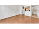 Spacious living room featuring wood-look flooring and an opening to the kitchen area at 8826 E Florida Ave # 117, Denver, CO 80247
