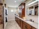 Well-lit bathroom with double sinks, sleek hardware, and a tiled walk-in shower at 3308 County Road 19, Fort Lupton, CO 80621