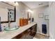 Elegant bathroom featuring dual glass vessel sinks, dark wood cabinets, and a separate shower stall at 3308 County Road 19, Fort Lupton, CO 80621