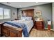 Comfortable bedroom with a decorative wood bed frame, matching nightstands, and natural light from the window at 3308 County Road 19, Fort Lupton, CO 80621