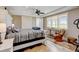Bright and airy bedroom featuring a ceiling fan and two large windows with wooden shutters at 3308 County Road 19, Fort Lupton, CO 80621
