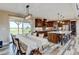 Spacious open kitchen and dining area featuring an island with bar seating and modern appliances at 3308 County Road 19, Fort Lupton, CO 80621