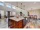 Open concept kitchen view with a large island, stainless steel sink, and connecting to the living area at 3308 County Road 19, Fort Lupton, CO 80621