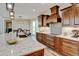 Open kitchen features a large island with seating, stainless steel appliances, and modern fixtures at 3308 County Road 19, Fort Lupton, CO 80621