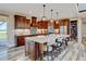 Open kitchen features a large island with seating, stainless steel appliances, and an adjacent pantry at 3308 County Road 19, Fort Lupton, CO 80621