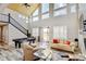 Bright living room features vaulted ceilings, large windows, a pool table, and comfortable seating at 3308 County Road 19, Fort Lupton, CO 80621