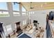 Open-concept living room with vaulted ceilings, a fireplace, and natural light at 3308 County Road 19, Fort Lupton, CO 80621