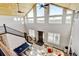 High angle view of the living room featuring vaulted ceilings, large windows, pool table, and comfortable seating at 3308 County Road 19, Fort Lupton, CO 80621