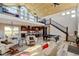 Spacious open-concept living room with soaring ceilings, wood beams, pool table, and chef's kitchen at 3308 County Road 19, Fort Lupton, CO 80621