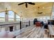 Open loft space with wood ceiling, large windows, and rustic wood-look floors at 3308 County Road 19, Fort Lupton, CO 80621