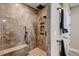 Modern tiled shower with built-in shelving and bench seat at 3308 County Road 19, Fort Lupton, CO 80621
