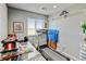 Functional spare room with a treadmill, glass top desk, and natural light filtering through the window at 3308 County Road 19, Fort Lupton, CO 80621