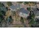 Aerial view showcasing the home's backyard with patio, lush lawn, and mature trees, offering privacy and tranquility at 7271 Brixham Cir, Castle Pines, CO 80108