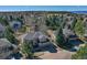 Aerial view displays the home's setting amidst mature trees, landscaped yard, and neighboring houses, perfect for families at 7271 Brixham Cir, Castle Pines, CO 80108