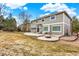Expansive backyard showcasing a well-manicured lawn, patio, and mature trees providing an inviting outdoor living space at 7271 Brixham Cir, Castle Pines, CO 80108