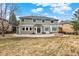 Backyard features a lush lawn, outdoor patio area with a fire pit and mature landscaping, ideal for relaxation and entertaining at 7271 Brixham Cir, Castle Pines, CO 80108