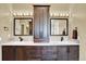 A bathroom with double sinks, a cabinet, and mirrors at 7271 Brixham Cir, Castle Pines, CO 80108