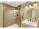 Bathroom features a glass enclosed shower, a pedestal sink with vanity lights and bronze hardware accents at 7271 Brixham Cir, Castle Pines, CO 80108