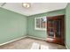 Bedroom featuring a light green wall and window near a cabinet at 7271 Brixham Cir, Castle Pines, CO 80108