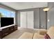 Bedroom featuring a TV, sliding closet doors and a large window at 7271 Brixham Cir, Castle Pines, CO 80108