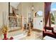 Grand foyer featuring a staircase, chandelier, and tile flooring with an abundance of natural light at 7271 Brixham Cir, Castle Pines, CO 80108