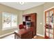 Home office featuring wood desk and hutch, natural light, and views of the outside at 7271 Brixham Cir, Castle Pines, CO 80108