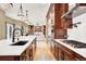 Bright, open kitchen featuring an island with seating, sleek appliances, and seamless flow to the living area at 7271 Brixham Cir, Castle Pines, CO 80108