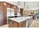 Modern kitchen boasting a large center island, stainless steel appliances, and dark wood cabinetry at 7271 Brixham Cir, Castle Pines, CO 80108