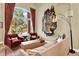 Stylish living room featuring elegant decor, large windows, and comfortable seating for relaxing and entertaining guests at 7271 Brixham Cir, Castle Pines, CO 80108