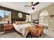 Spacious bedroom with a cozy seating area, fireplace, large bed, and stylish decor at 7271 Brixham Cir, Castle Pines, CO 80108
