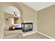 View of a bedroom with a partial view of a fireplace, an upholstered bench, and barn door closet at 7271 Brixham Cir, Castle Pines, CO 80108