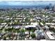 Wide aerial shot shows the home nestled among mature trees and other homes, with the city skyline in the distance at 1258 N Downing St, Denver, CO 80218