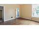 A yellow bedroom features a window, hardwood floors, and a door leading to another room at 1258 N Downing St, Denver, CO 80218