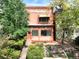 Charming brick home featuring a cozy front porch and well-maintained landscaping at 1258 N Downing St, Denver, CO 80218