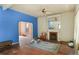 View of living room with fireplace, rug, doorway to another room, and ceiling fan with light at 1258 N Downing St, Denver, CO 80218