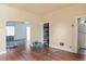A light yellow room features wood floors, a closet, and a view into another room at 1258 N Downing St, Denver, CO 80218
