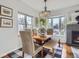 Bright dining room featuring chandelier, fireplace, hardwood floors, and bench seating at 1160 Holly St, Denver, CO 80220