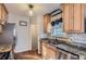 Updated kitchen with granite counters, stainless steel appliances, and wood cabinets at 1160 Holly St, Denver, CO 80220