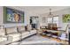 Living room with fireplace, dining area, and hardwood floors at 1160 Holly St, Denver, CO 80220