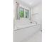 Bright bathroom features a tub under a window with bright natural light and bright white subway tile at 6075 S Filbert Ct, Centennial, CO 80121
