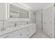 Bright bathroom features a double vanity with modern sinks, a large mirror with integrated lighting, and tiled floors at 6075 S Filbert Ct, Centennial, CO 80121