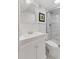 Bathroom featuring white vanity, toilet, and tiled shower with glass doors at 6075 S Filbert Ct, Centennial, CO 80121